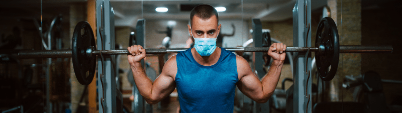 nexo_man doing squats with mask on