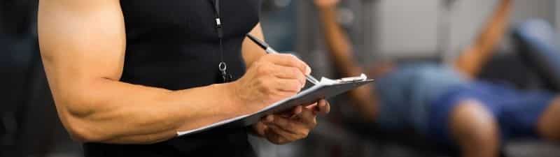 nexo_writing on clipboard in gym